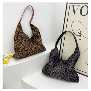 Close-up of leopard print tote bags in brown and grey with premium leather straps