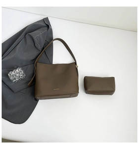 Detailed macro view of dark brown pebbled leather hobo bag set with matching inner pouch