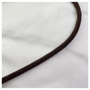 Detail shot of the dark brown faux suede drawstring on a bucket bag showing soft plush texture