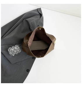 Top view of dark brown leather bucket bag showing spacious interior and suede lining