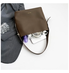 Macro view of the large capacity dark brown leather tote bag showing internal storage space