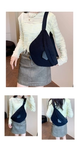 Detail view of black corduroy crossbody bag showing ribbed texture and metal D-ring hardware