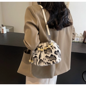 Detail of faux mink fur crossbody bucket bag with black and white leopard print and beaded handle