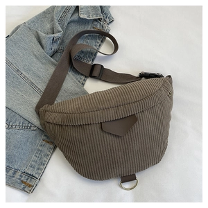 Detail showing deep brown corduroy texture and adjustable strap of the crossbody chest bag