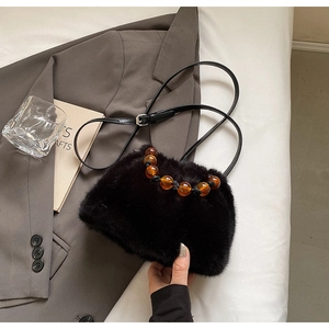 Chic black faux fur bucket bag featuring vintage amber bead handle and leather strap