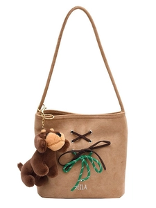 Brown faux suede bucket shoulder bag with woven strap details and plush dog charm
