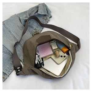 Spacious corduroy crossbody bag with adjustable strap and large internal capacity