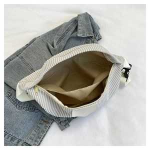 Detailed interior view of corduroy waist bag showing inner pocket and brown lining
