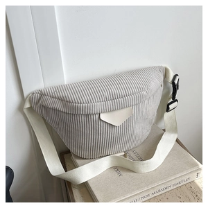 Detail of corduroy waist bag showing soft ribbed fabric texture and canvas strap on minimalist set
