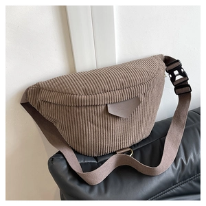 Close-up of brown corduroy waist bag showing ribbed texture and wide strap details