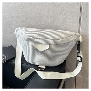 Close-up of light gray corduroy waist bag with semi-circle design and white canvas strap