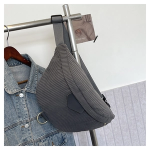 Close-up of grey corduroy chest bag texture with adjustable strap and metal hardware