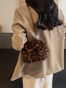 Faux mink leopard bucket bag with amber beaded handle and leather strap on model