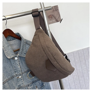 Detail of coffee corduroy belt bag with adjustable strap and metallic ring accents