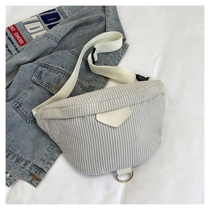 Detail of light grey corduroy crossbody bag texture with white strap and geometric buckle