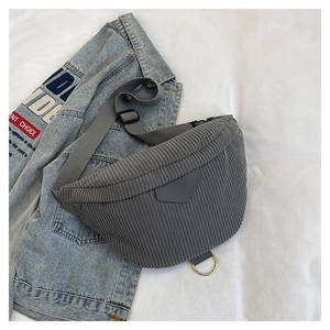 Detail of gray corduroy texture and golden D-ring on the versatile crossbody waist bag