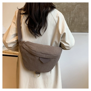 Brown corduroy crossbody chest bag detail showing the adjustable strap and metal D-ring
