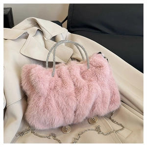 Détail du sac nuage en peluche rose avec poignées en strass étincelants et chaîne en argent