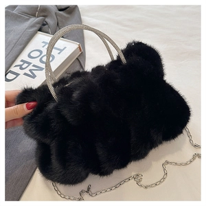Détail du sac à main en peluche noire avec poignée en strass étincelants et chaîne argentée