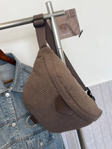 Brown corduroy crossbody chest bag with adjustable strap and leather trim detail