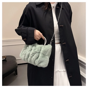 Détail du sac à main en fausse fourrure vert clair avec poignée strass et chaîne argent