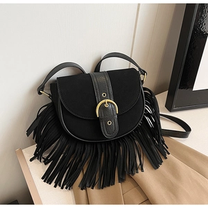 Detailed view of black suede saddle bag with fringe trim and golden buckle detail