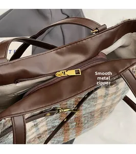 Detailaufnahme des Metallreißverschlusses und des Karostoffs der großen Shopper-Tasche
