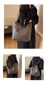 Detailed view of the dark brown retro leather tote bag with functional zippers and straps