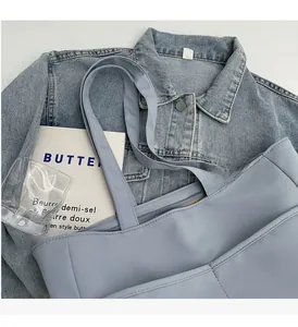 Détail de la poignée de cabas en nylon bleu clair et de la fermeture éclair solide