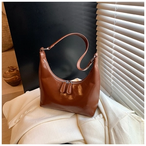 Dettaglio della borsa hobo marrone caramello con finitura lucida e doppia cerniera