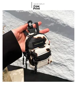 Detailed view of the cow print mini bag keychain with high-quality plastic clip