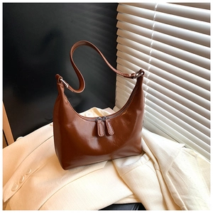 Dettaglio della borsa hobo marrone caramello con finitura lucida e doppia zip esterna