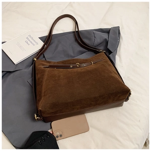 Deep brown suede and leather tote bag featuring belt decor and large storage capacity