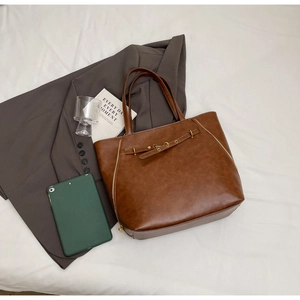 Top view of a vintage brown PU leather tote bag with gold zippers and metal hardware
