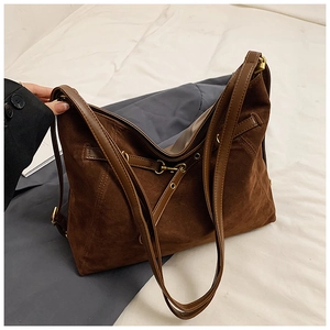 Detail view of deep brown vintage tote showing suede texture and antique bronze hardware