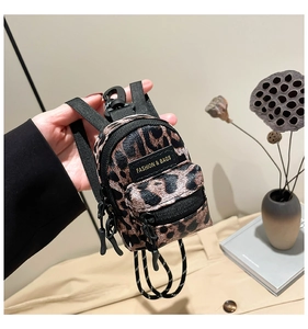 Detail view of mini leopard print crossbody bag with fashion label and zipper closure