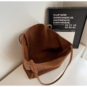 Detailed overhead view of a large brown suede tote bag showing soft texture and spacious interior
