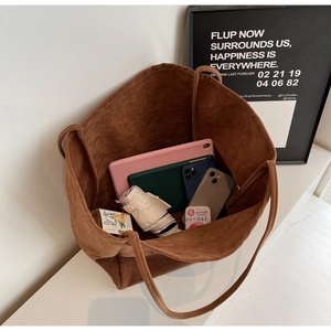 Top view of large brown suede tote bag interior showcasing massive storage capacity