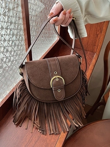 Vintage brown suede saddle bag with fringe tassels and horseshoe buckle for women