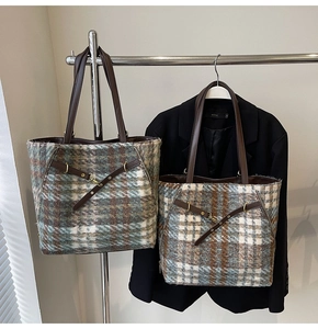 Detailansicht großer Tweed-Plaid-Tragetaschen in Grün und Blau mit Ledergriffen