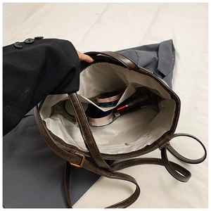 Detailed interior of vintage brown tote bag showing compartments and spacious storage