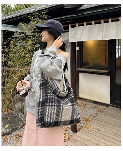 Close-up of winter plaid tote bag in grey and black wool fabric with large capacity