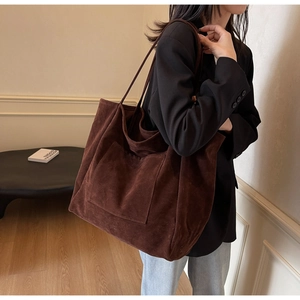 Detailed view of dark brown suede tote bag with front pocket for daily commute