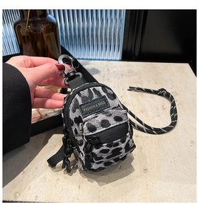 Mini leopard print crossbody bag for girls featuring dual zipper pockets and a fashion tag