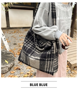 Detail of grey plaid faux fur tote bag showing thick wool-like texture and soft winter fabric