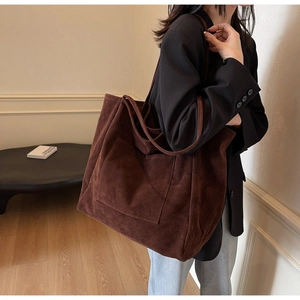 Deep brown faux suede oversized tote bag featuring a front pocket and long shoulder straps