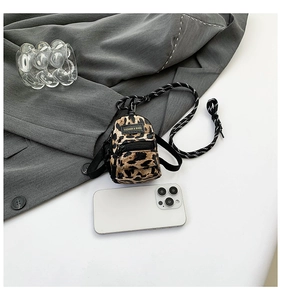 Mini leopard print crossbody bag detail with black and white strap and fashion label