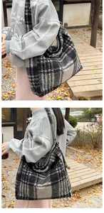 Close-up of the thick wool fabric texture and black and white plaid pattern on the tote bag