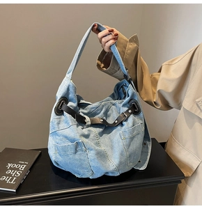 Detailansicht der hellblauen Denim-Textur und schwarzem Lederriemen mit Metallschnalle