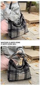 Detail of checkered faux shearling tote bag showing plush texture and wide shoulder strap
